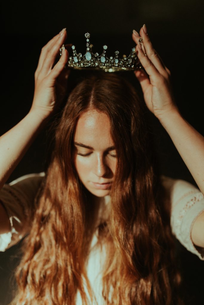 girl putting a crown on