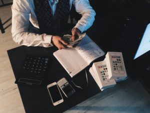 successful-looking man counting dollars