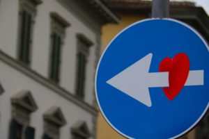 traffic arrow cutting through heart as as symbol of eros, one of the 7 kinds of love