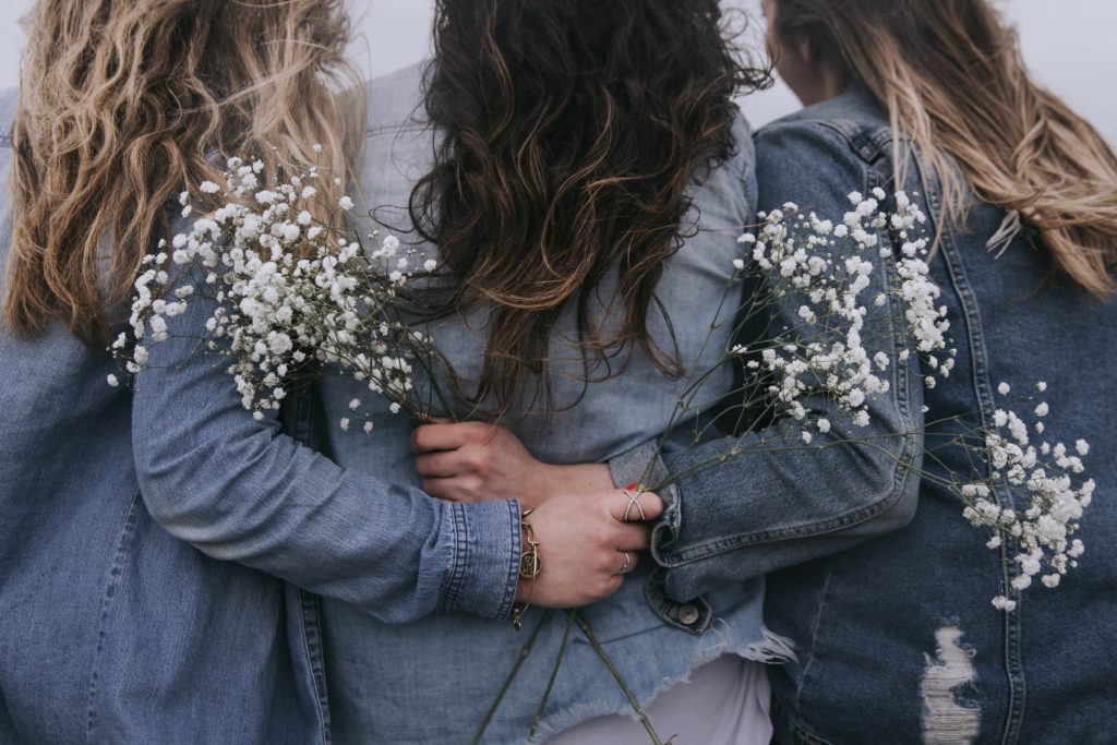 three sisters hugging as a symbol os storge one of the 7 kinds of love