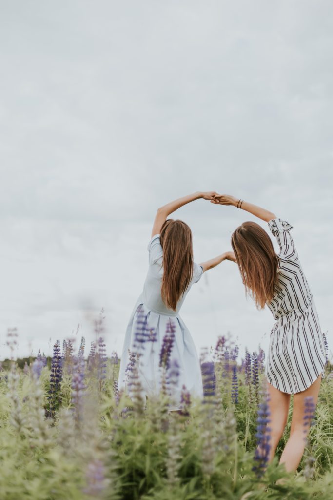 sisters on a field representing philia