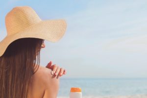 girl applying sunscreen as part of her beauty routine