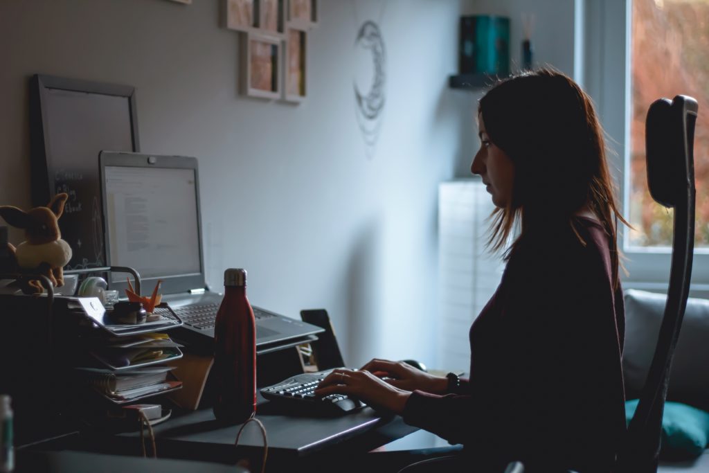 woman sitting in front of laptop in a way that prevents most cvs symtoms