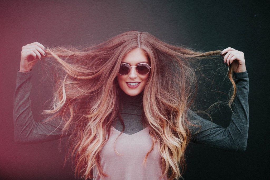 girl holding some strands of hair up