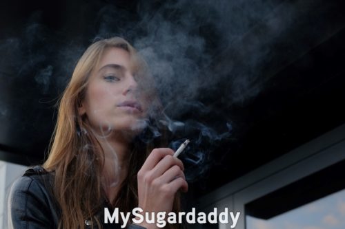 fetishist sugar baby smoking a cigarette