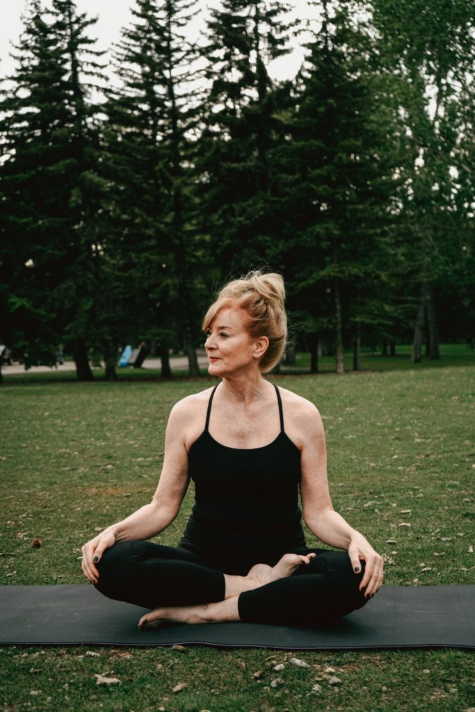 woman on yoga mat at class for pelvic floor exercise 