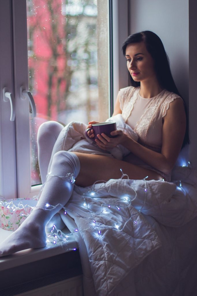 confident girl enjoying her me-time on window sill