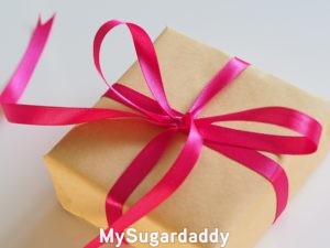 gift for sugar baby in beige wrapping with pink ribbon