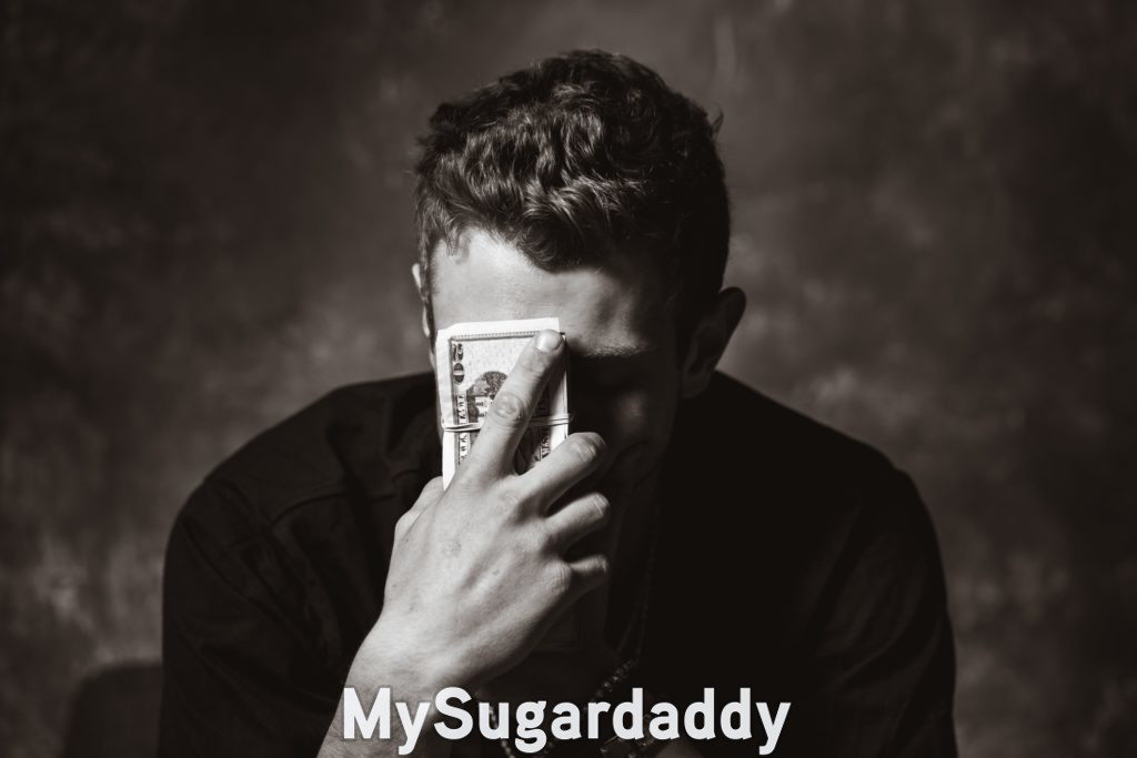 sugar daddy frustratingly holding money to his face because the relationship feels transactional