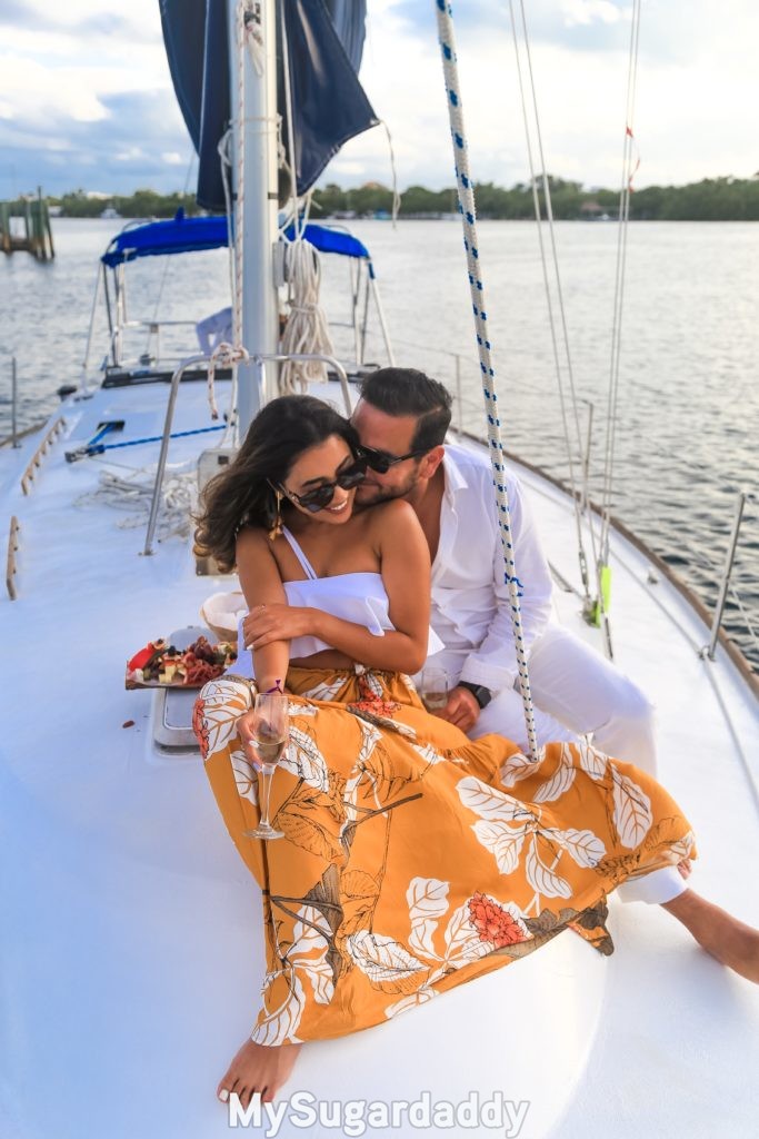 sugar baby that knows what is important to her with successful sugar daddy on yacht