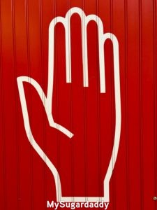 painting of hand on wall symbolizing scam 