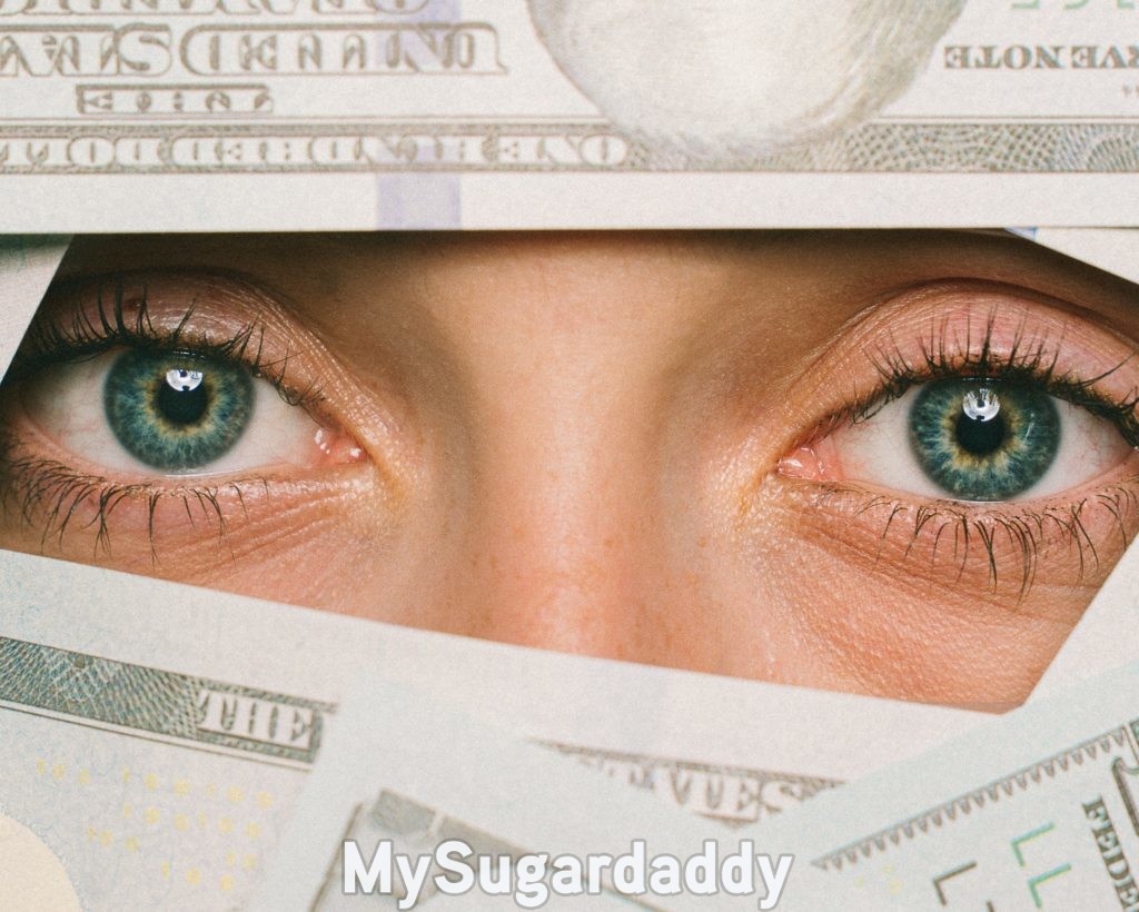 woman with her monthly allowance partially covering her face