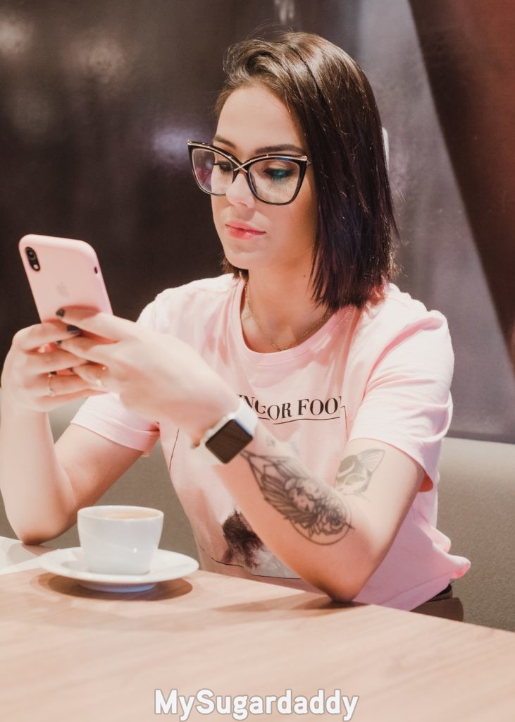 sugar daddy scam sugar baby looking skeptically at her phone